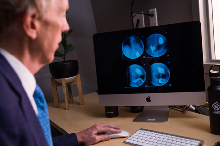 Dr. John Hunter reviewing radiology images
