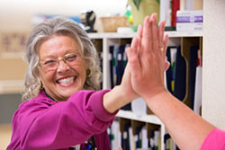 Older nurse giving a high five