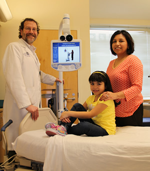 Physician on screen in pediatric critical care unit