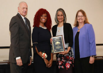 Dr. Sima Desai receiving award 