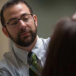 Dr. Eric Simpson examines a patient in a visit
