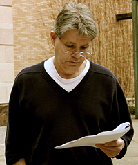 Gary Westbrook reading a manuscript