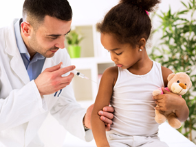 A healthcare provider gives a child a flu vaccine.