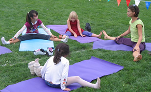 Children practicing yoga on the soccer field