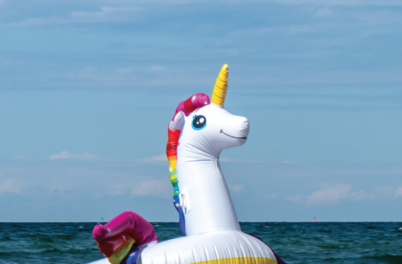 An inflatable giant unicorn floating on the ocean