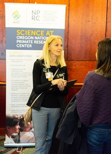 A representative from the Oregon National Primate Research Center speaks to a lecture patron.