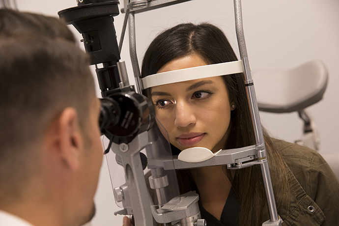 A woman having an eye exam for contact lenses