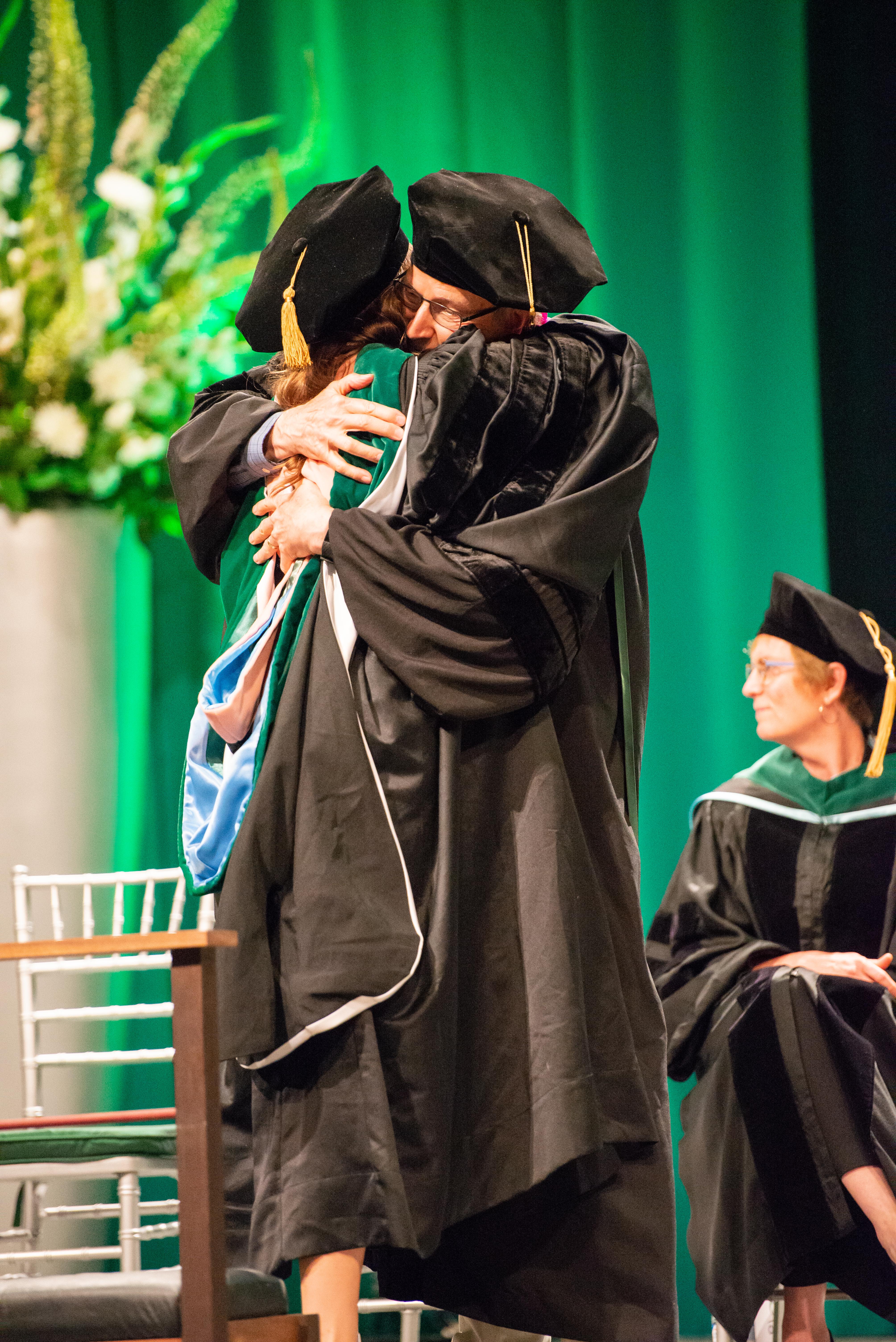 Convocation 2019 - School of Medicine Graduate Studies hooding ceremony, degree recipient hugging faculty mentor