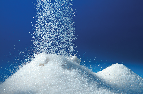 Sugar piling up on a blue background