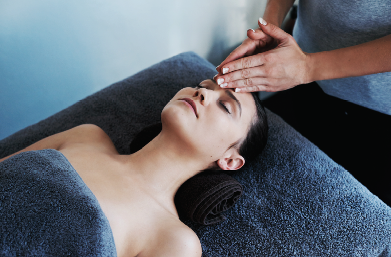 Woman in blue towel gets scalp massage
