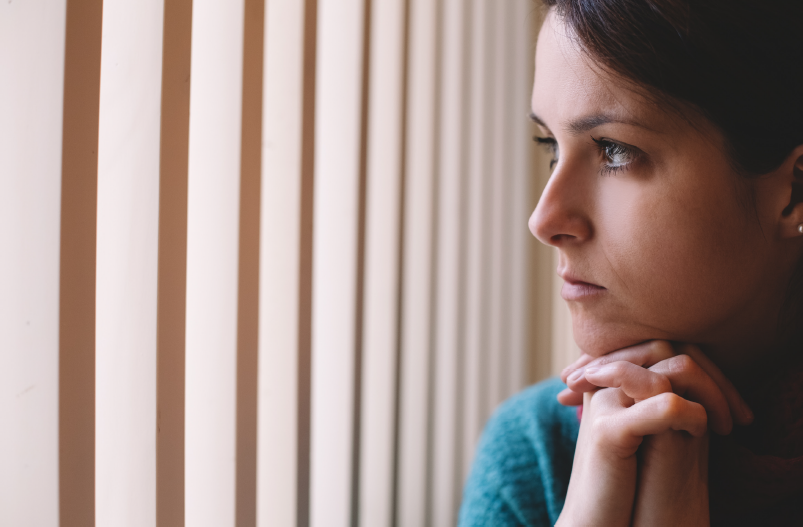 woman looks out of window