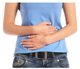 A person holding their stomach due to gastrointestinal issues