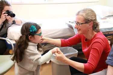 Dr. Penelope Hogarth with young visitor to OHSU