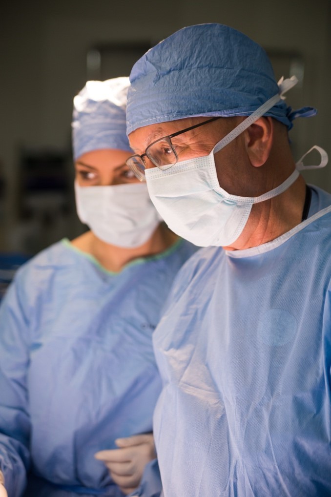 The surgical teams at the Knight Cancer Institute, pictured here in scrubs and masks, perform dozens of complicated pancreatic surgeries a year.