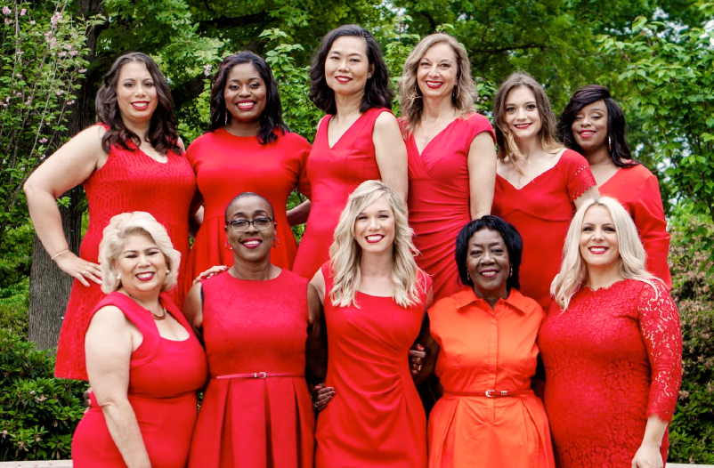 11 women heart disease and stroke survivors in red dresses pose for camera