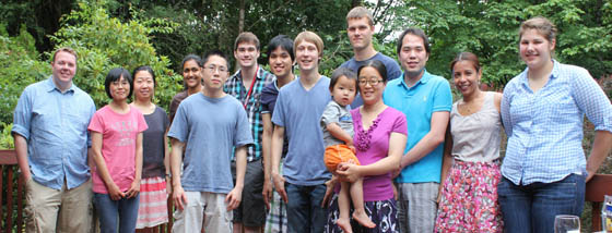 The people of Yantasee Lab, standing outside, smiling in front of trees while attending an informal gathering.