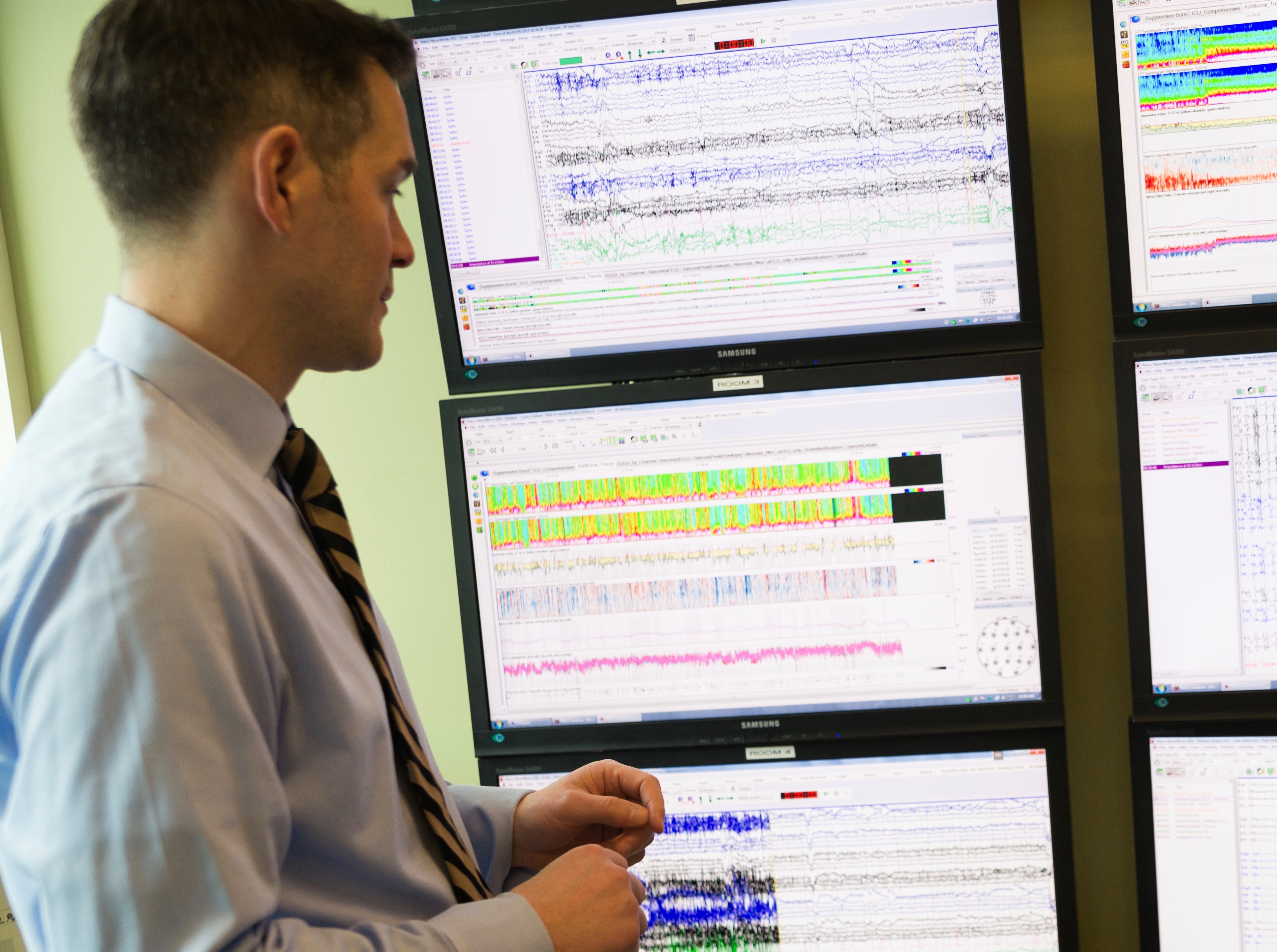 Dr. Paul Motika, a neurologist on our team, looks at detailed monitoring results in the EMU, Epilepsy Monitoring Unit