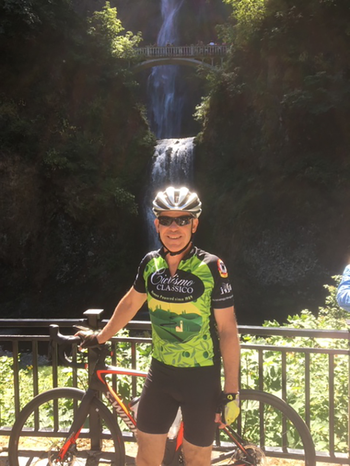 Dr. Wilson poses with his bike at Multnomah Falls on his Tour de Casey ride.