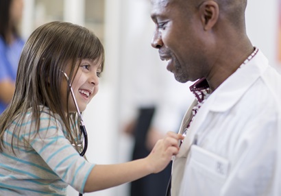 Child with Stethescope listening to doctor's heartbeat