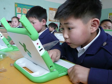 a young student looking at a computer