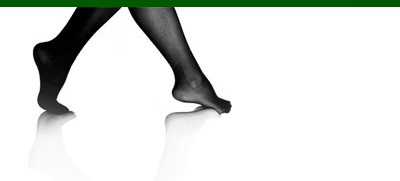 A pair of legs wearing stockings, walking on a white background