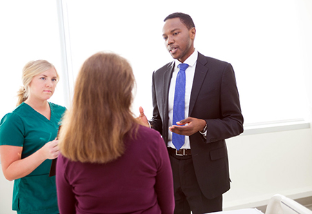 Dr. Josiah Orina speaks with patient