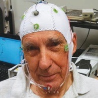 Ed Parker wearing a cap with electrodes affixed to it on his head