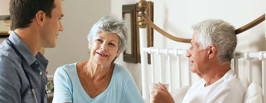 Pharmacy Home Infusion Services - banner photo of provider with patient and spouse