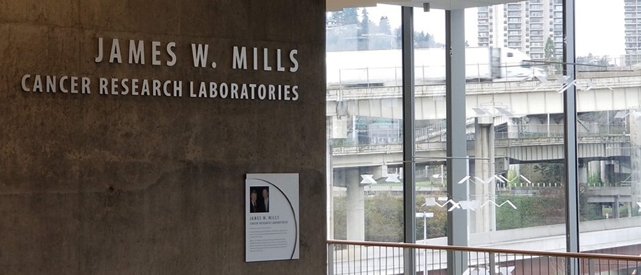 A photo of entrance to the "James W. Mills Cancer Research Laboratories" at OHSU.