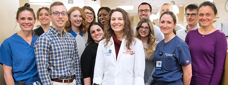 A picture of Dr. Nicole Fett and a group of residents in a clinic