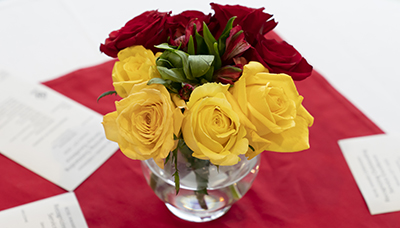 Golden Rose Award flowers atop invitation announcements
