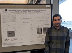 Pedro Martín-Acosta standing next to his research poster