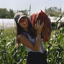 Alaina Spencer holding a large bag of produce