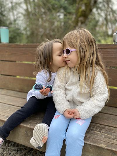 Doernbecher patient Sienna Balumas with her sister in a park