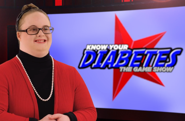 Woman standing in front of a screen saying 'Know your Diabetes; the game show'