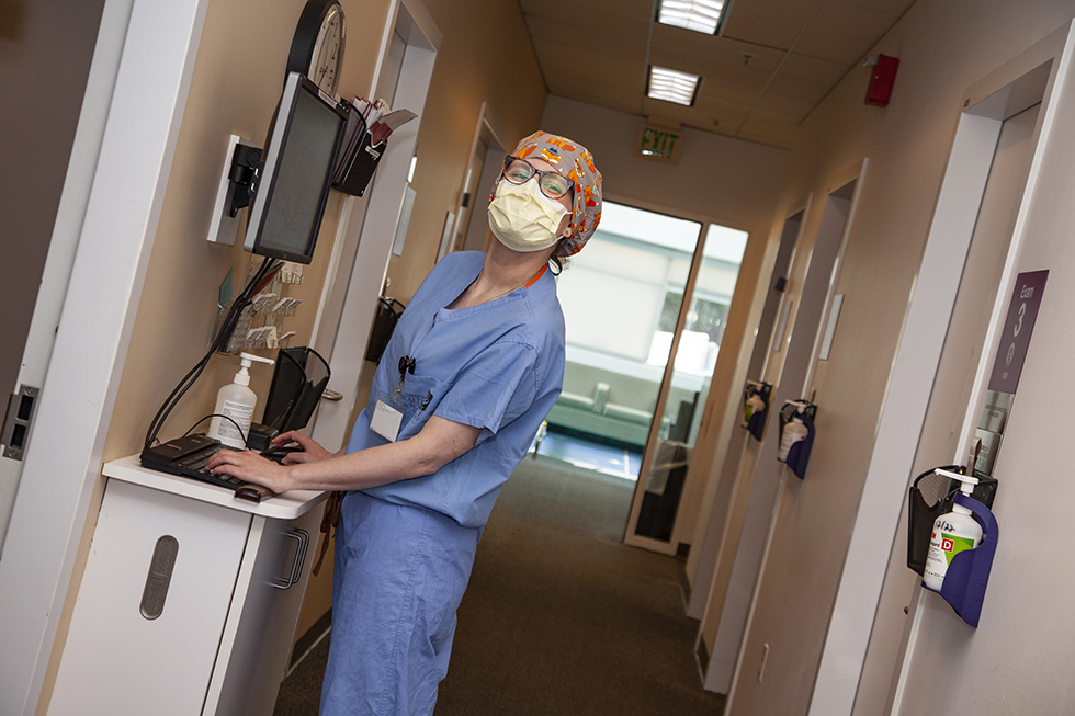 Ophthalmologist smiles while reviewing patient charts