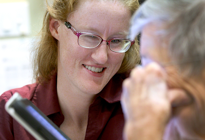 Occupational Therapist assists a patient with a reading device at Casey's Vision Rehabilitation institute.