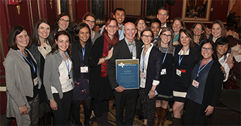 OHSU's Family Planning Program Team smiling next to one another at an event honoring Dr. Mark Nichols.