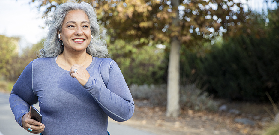 Woman jogging outside on a fall day.