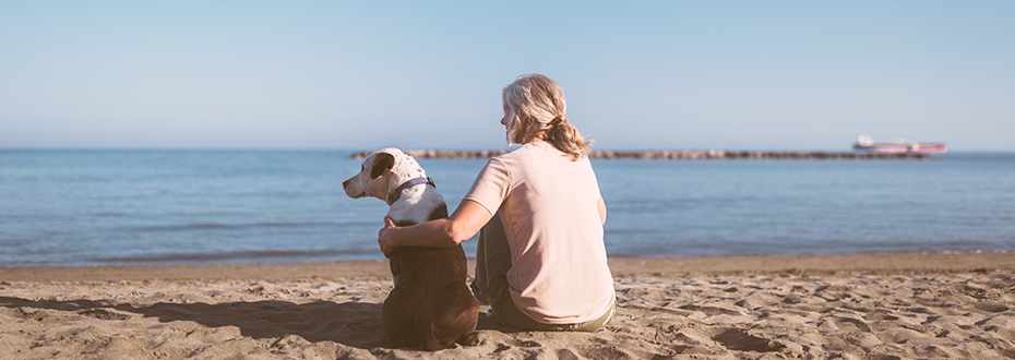 Woman and dog on beach