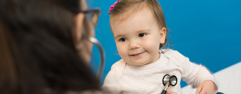 Photo of a health care provider with a smiling baby