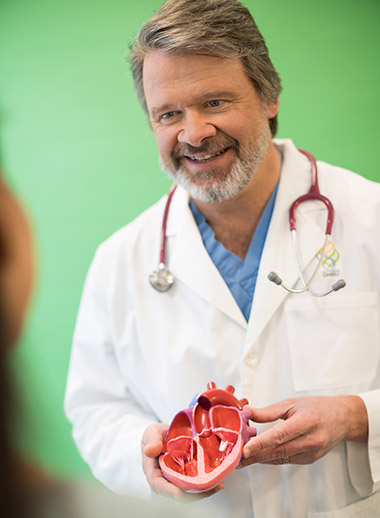 Dr. Grant Burch with a model of a heart