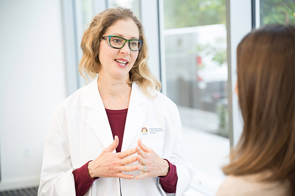 A female doctor speaking to a woman at OHSU Doernbecher Children's Hospital.