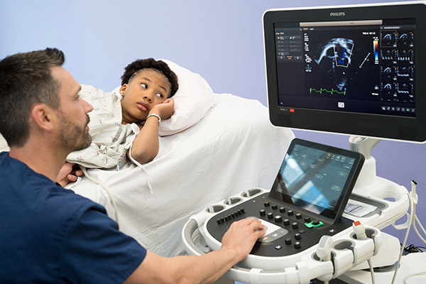 Pediatric echocardiography specialist Matt Janssen with a patient