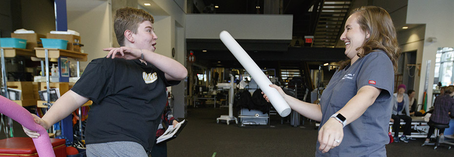Will Van Dyke, who was born with a heart condition, playfully works out with physician assistant Ali Lyman
