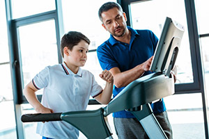 Stock photo of a child jogging on a treadmill for a supervised exercise stress test