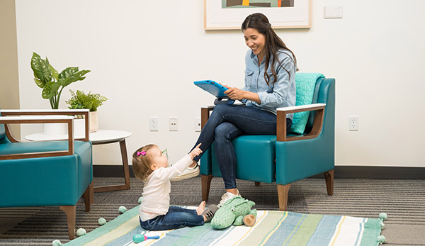 Parent and a baby in a Doernbecher waiting room