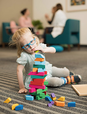 Doernbecher patient Foxy Kusin playing with blocks