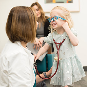 Doernbecher patient Foxy Kusin playing with Dr. Kathryn Holmes