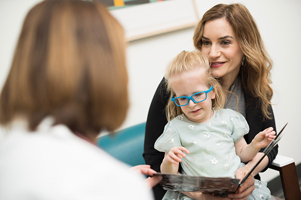 Doernbecher patient Foxy Kusin with her mother Shana Kusin reading a book